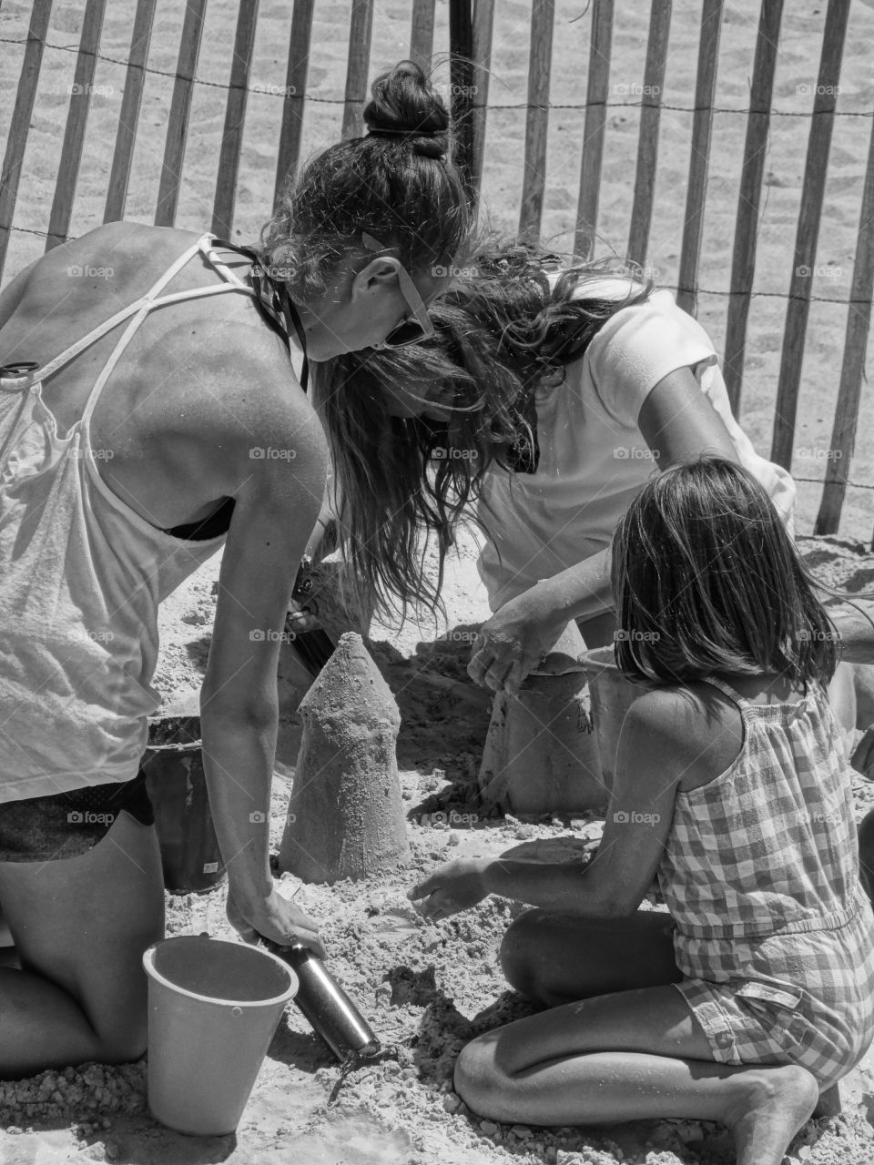 sand castle lessons. Teaching the younger ones to build sandcastles during the 2014 Hampton Beach sand sculpture event.