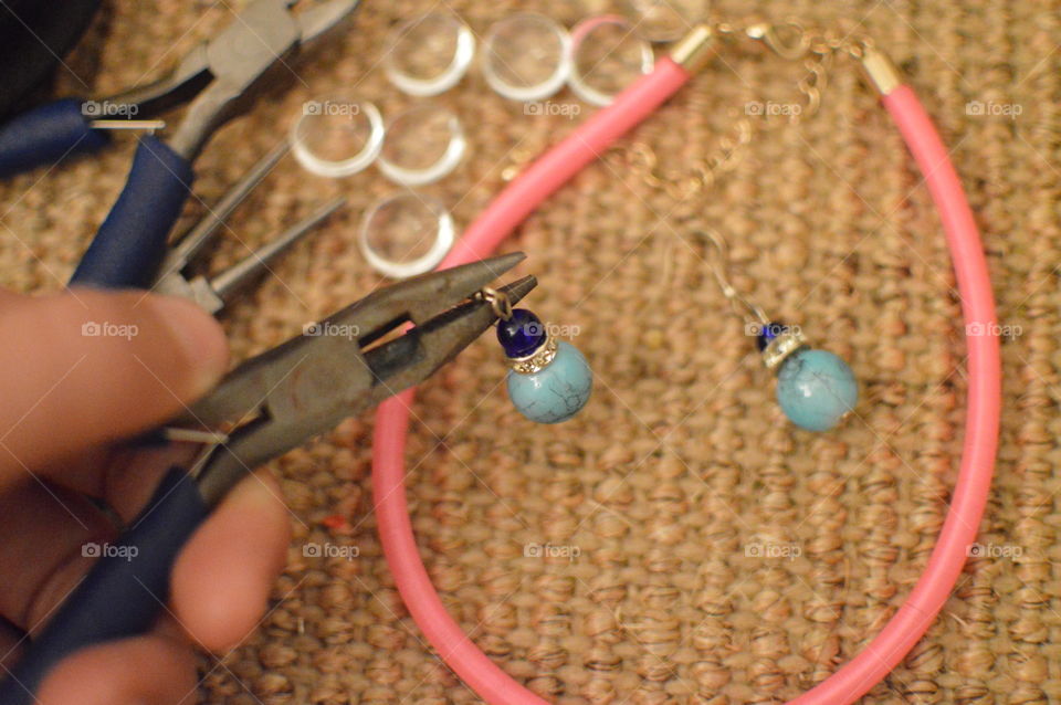 Cropped hand image making jewellery