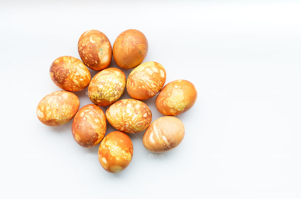 Too view of isolated orange Easter eggs on a white background.