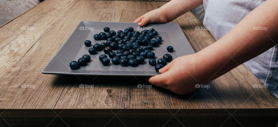 Hands and blueberries