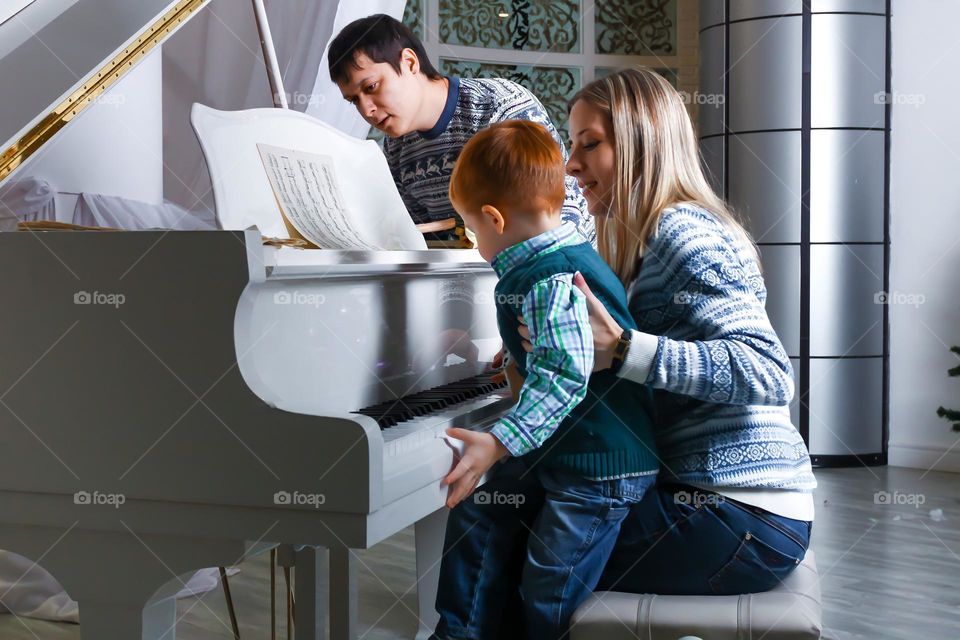 Family with a child playing the piano
