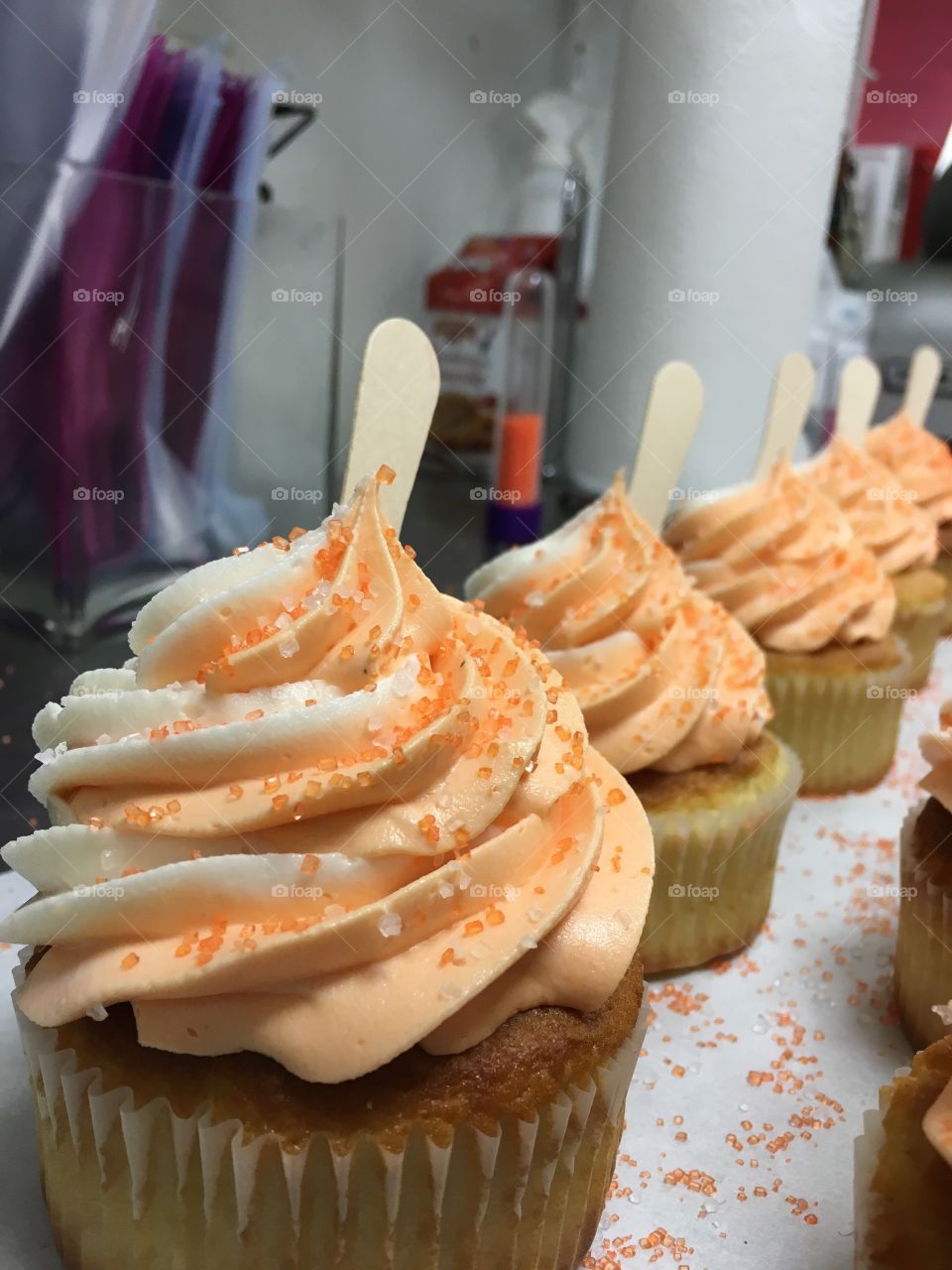 Mmmm...orange creamsicle cupcakes!! Vanilla cake with orange cream frosting! Topped with sprinkles and a popsicle stick!