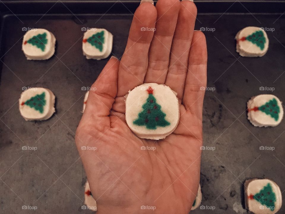 Placing decorative cookie dough on baking sheet to pop them in the oven and watch them cook