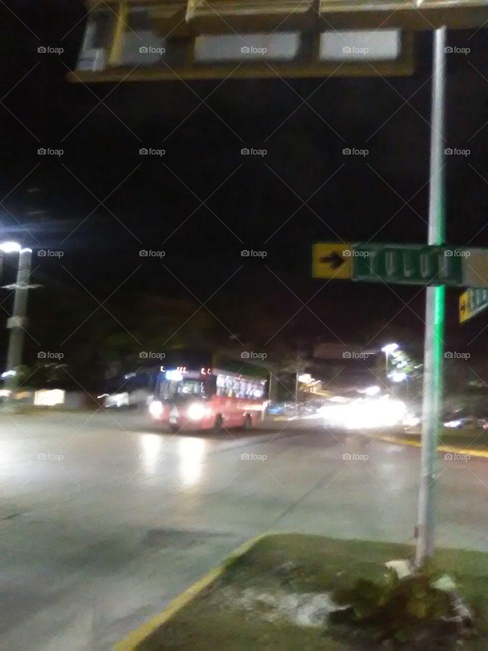 Avenida Tulum and Avenida Kukulcán in Cancún, Quintana Roo, México. Intersection near crosswalk. Bus flying thru intersection.