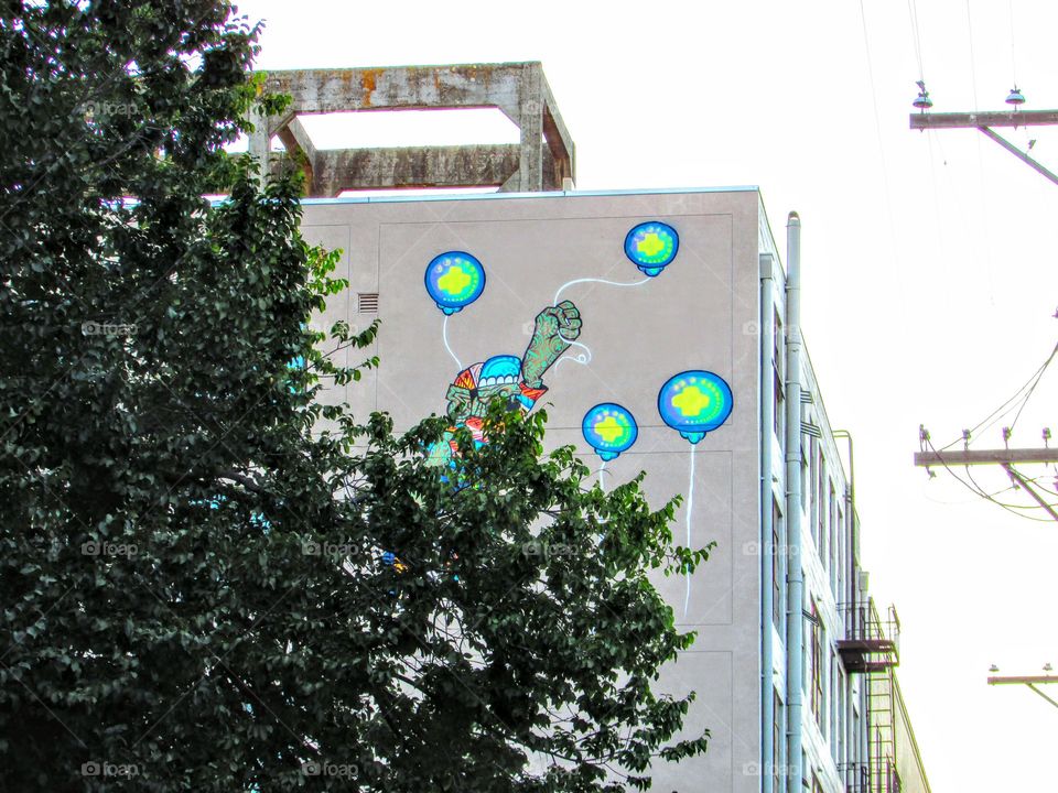 Up Up and Away on my colorful balloons on the side of a building in downtown Sacramento