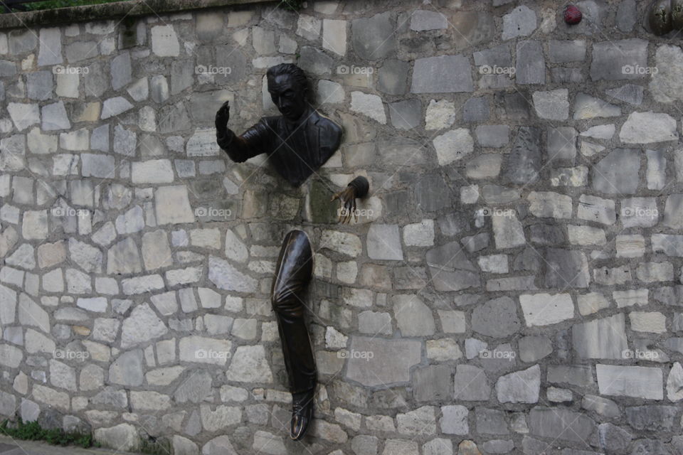 Statue Made of iron wedged between the tiles