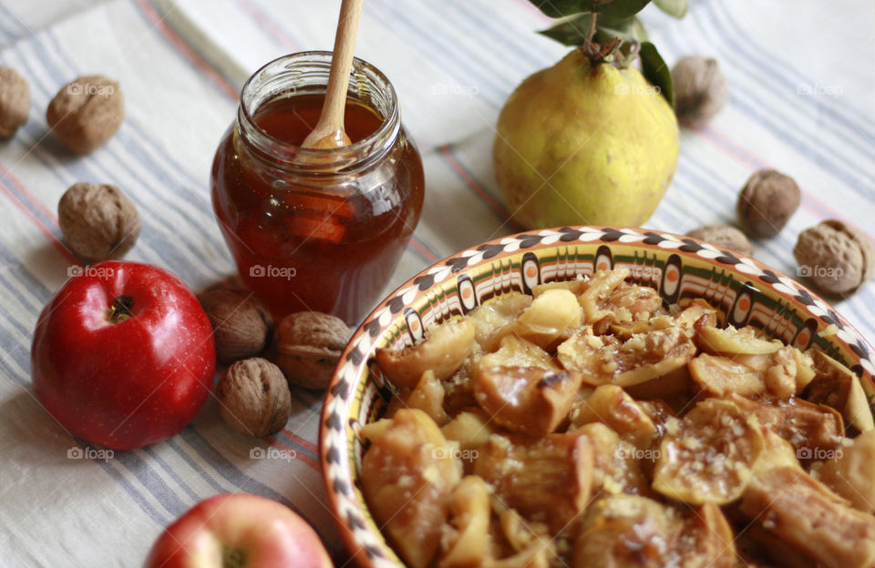 Baked apples, quince, honey, walnuts