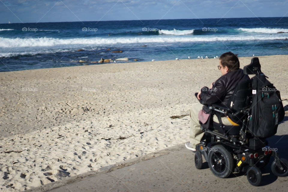 Wheelchair traveler at Bronte Beach, Sydney 