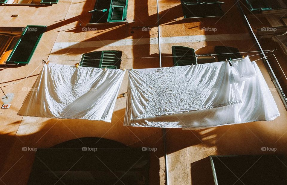 Bed sheets drying outside the window 