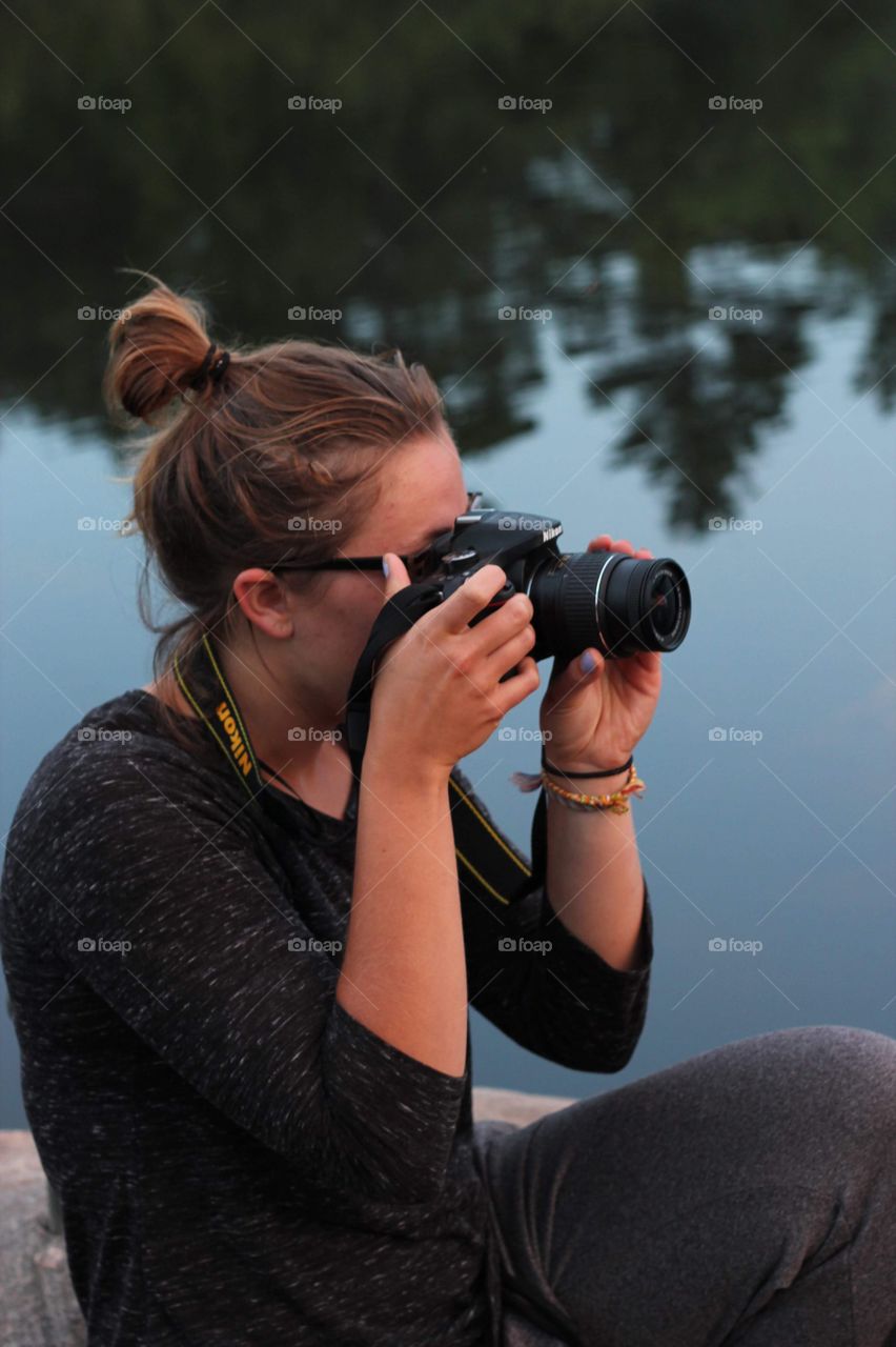 Girl taking pictures at sunrise