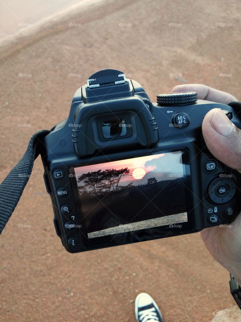 Photographer showing Sunset on his camera