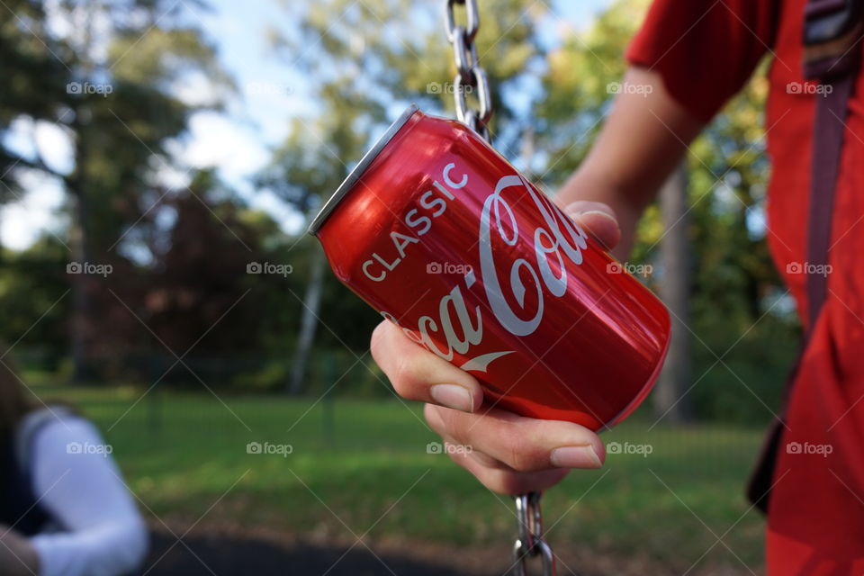 Grab a Classic red can = Coca Cola 