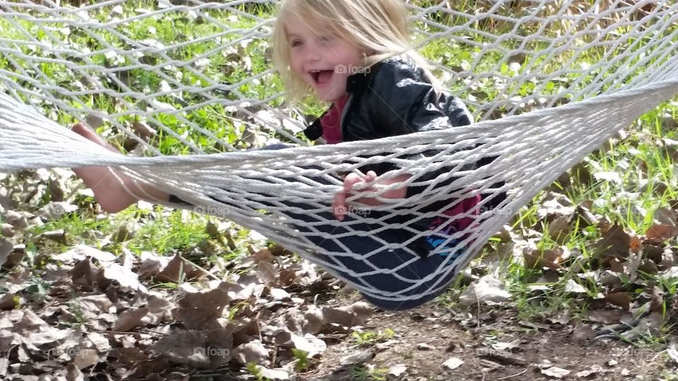 Happy child. playing in a hammock