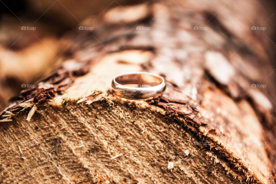 Wedding ring. Golden ring lying on a wooden trunk