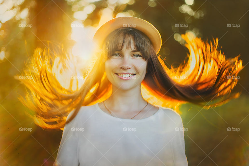 Portrait of young beautiful woman at summer evening 