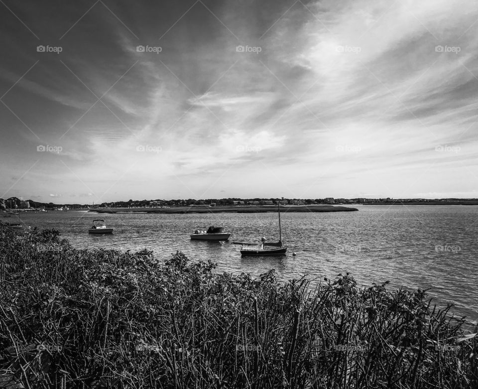 The ocean is just as beautiful in black and white.  Quiet scene with sailboats below a big sky 