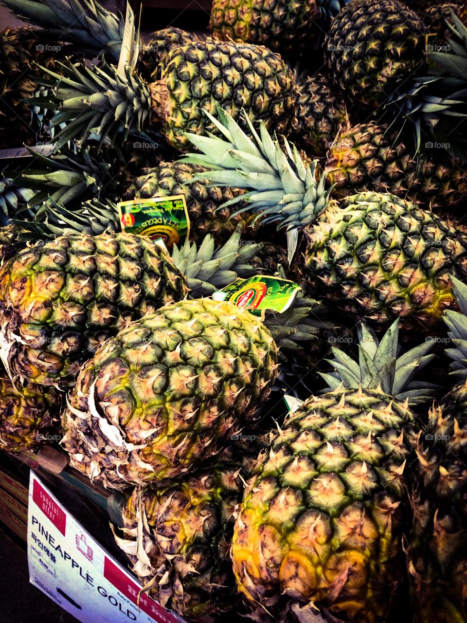 Pineapples for sale at a grocery store.