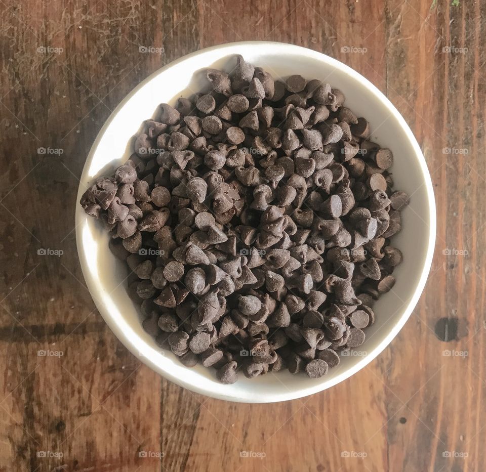Bowl of Chocolate Chips on Wooden Table 