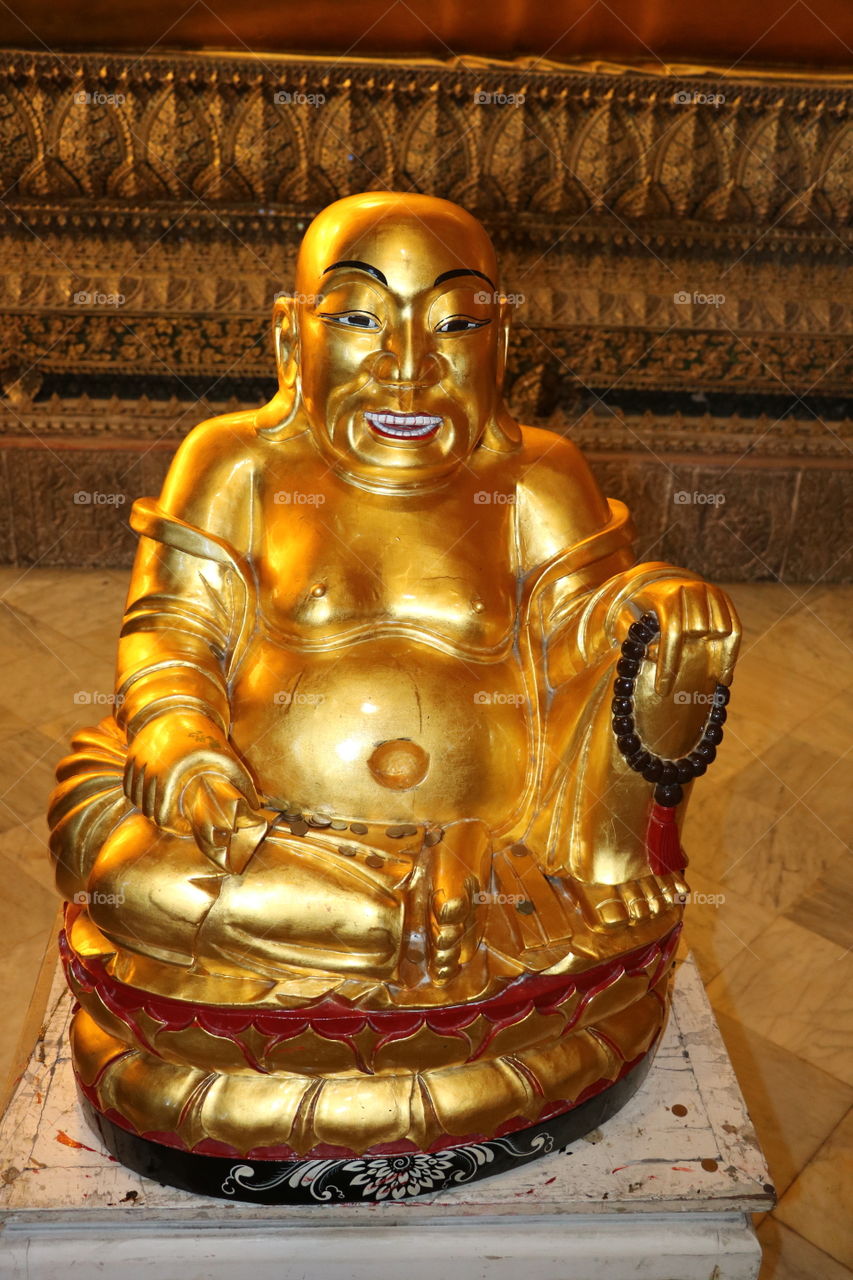 Buddha Statue in Bangkok Thailand. This particular one has a big belly.