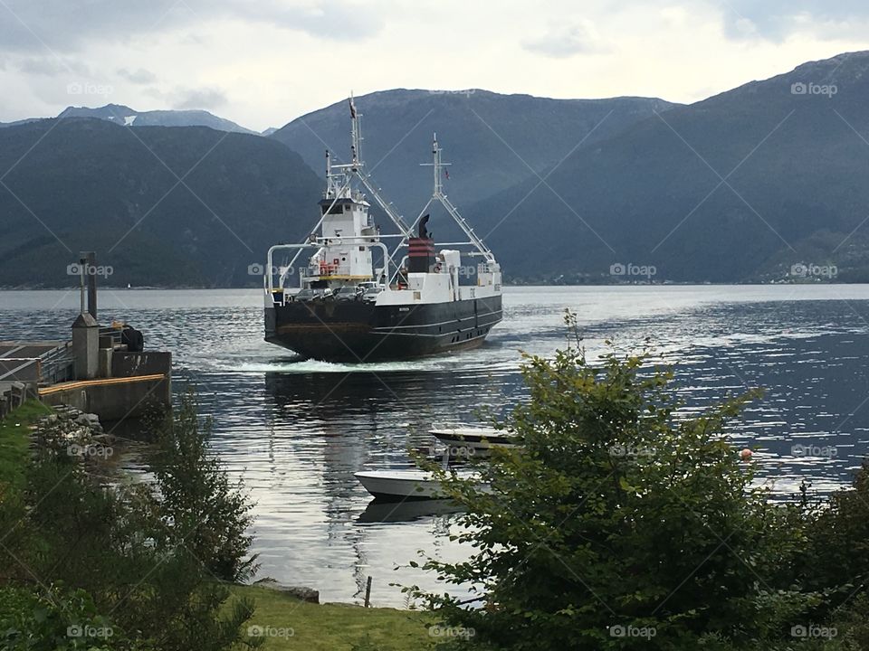 A ferry arriving Tørvikbygd, Norway after crossing the Hardangerfjord 