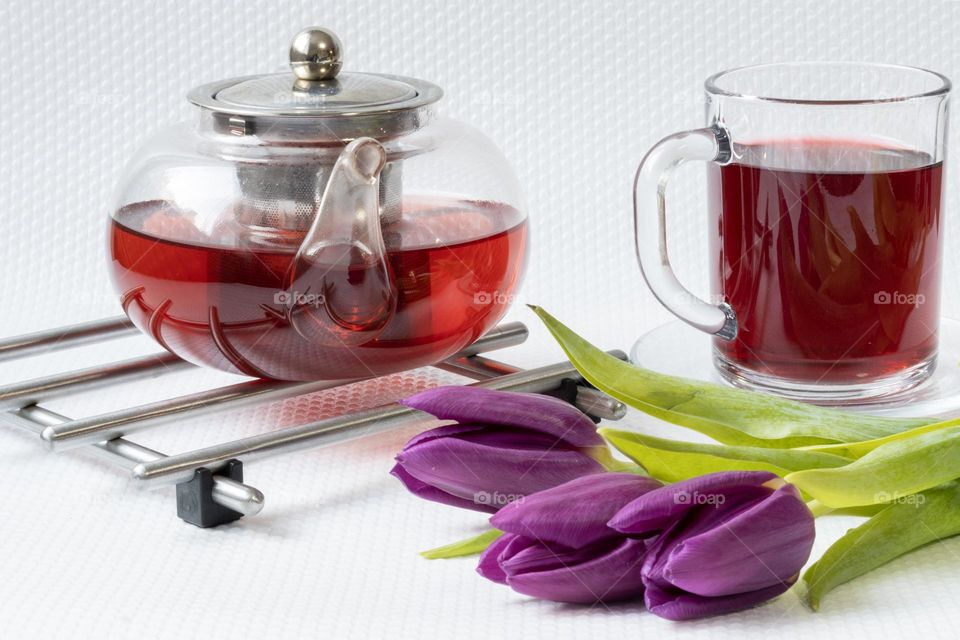 Cup of tea and beautiful purple flowers 