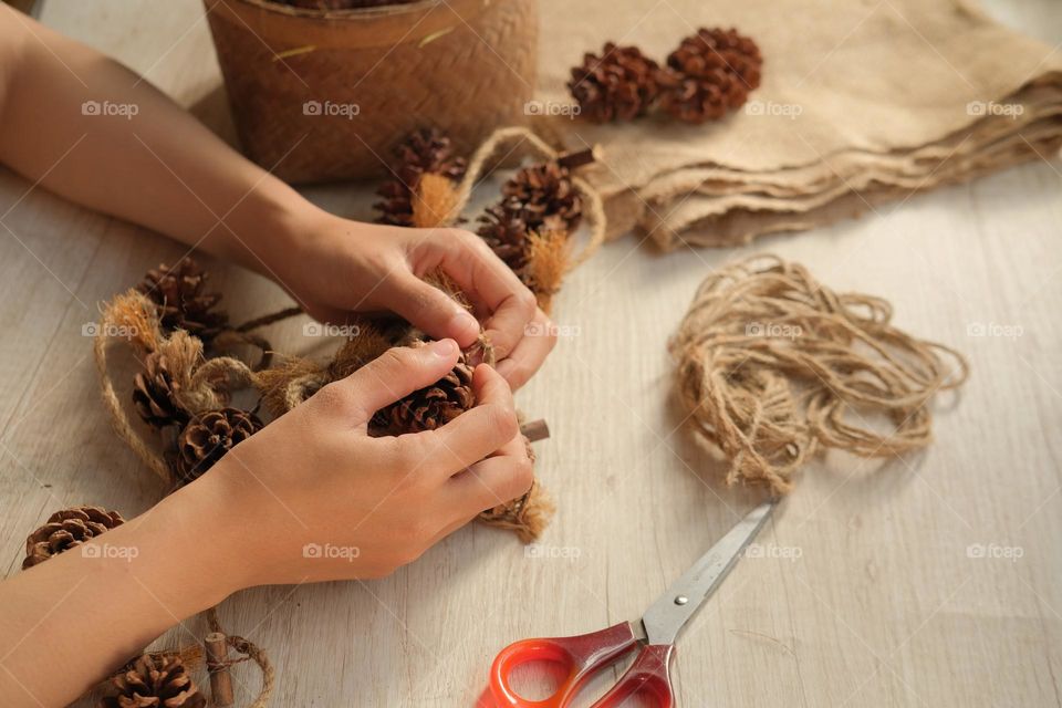 making decorations from pinecones and rope