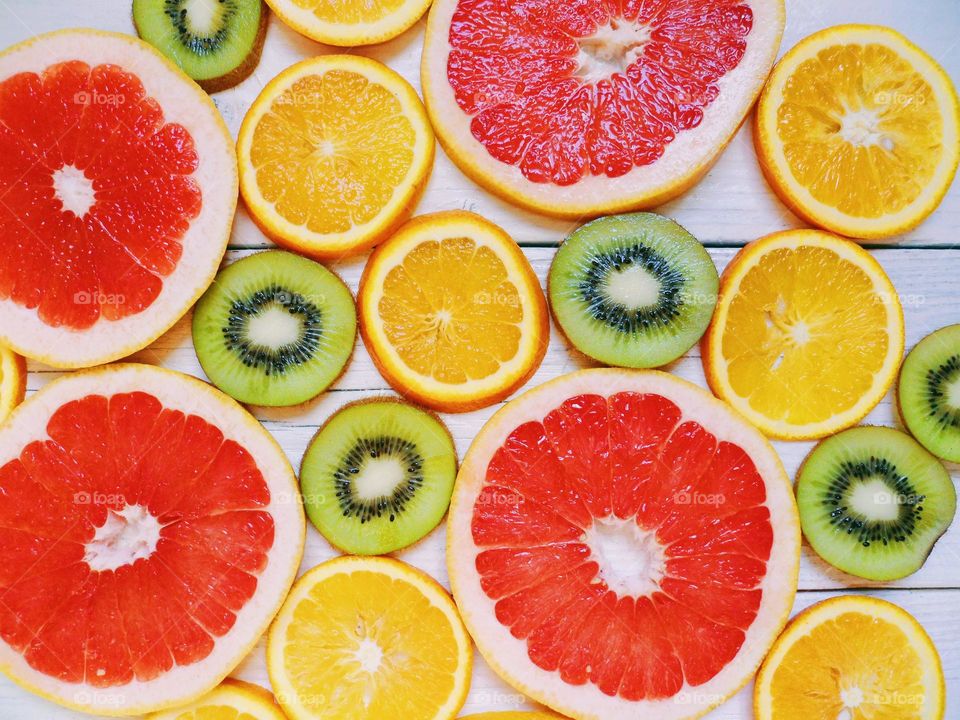 sliced ​​grapefruit, orange and kiwi