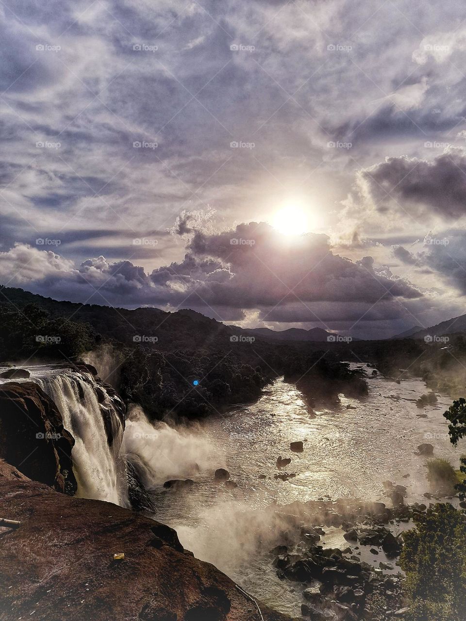 Drink to nature wine, just go to Athirapally waterfalls in Trissur, Kerala, and witness the sunset. This photo can be used for advertising tourism in Kerala , India, and also can be used as a desktop background.