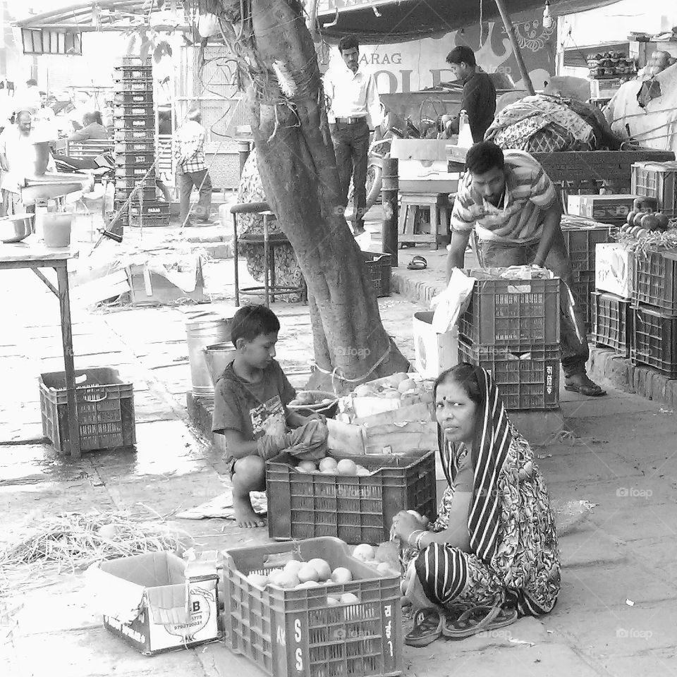 Suspicious looks from lovely and hard working lady in the streets of Varanasi who could sing songs of the global labor camp...