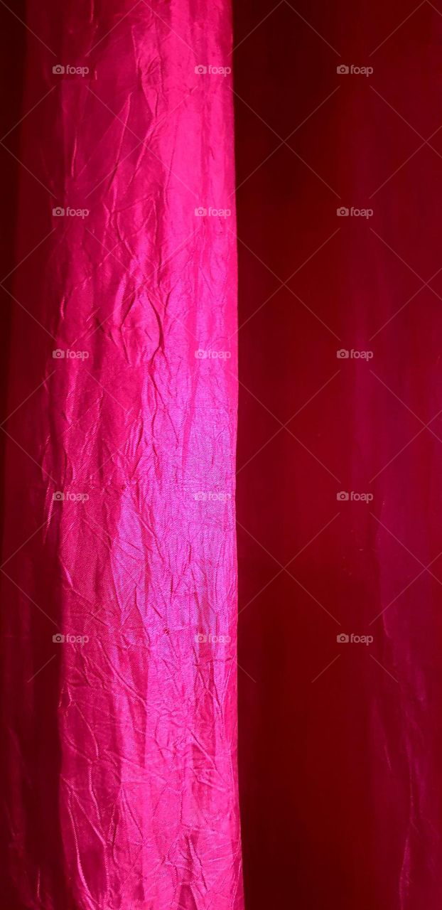 somewhat ruffled eye-catching curtain with red, magenta color