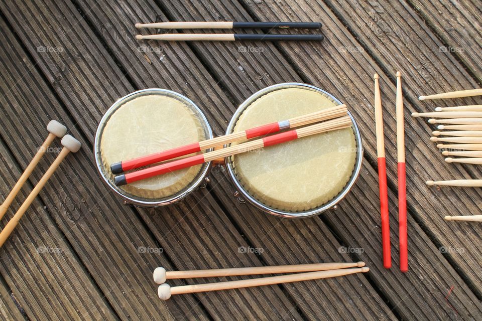 Various drumsticks on a set of bongos