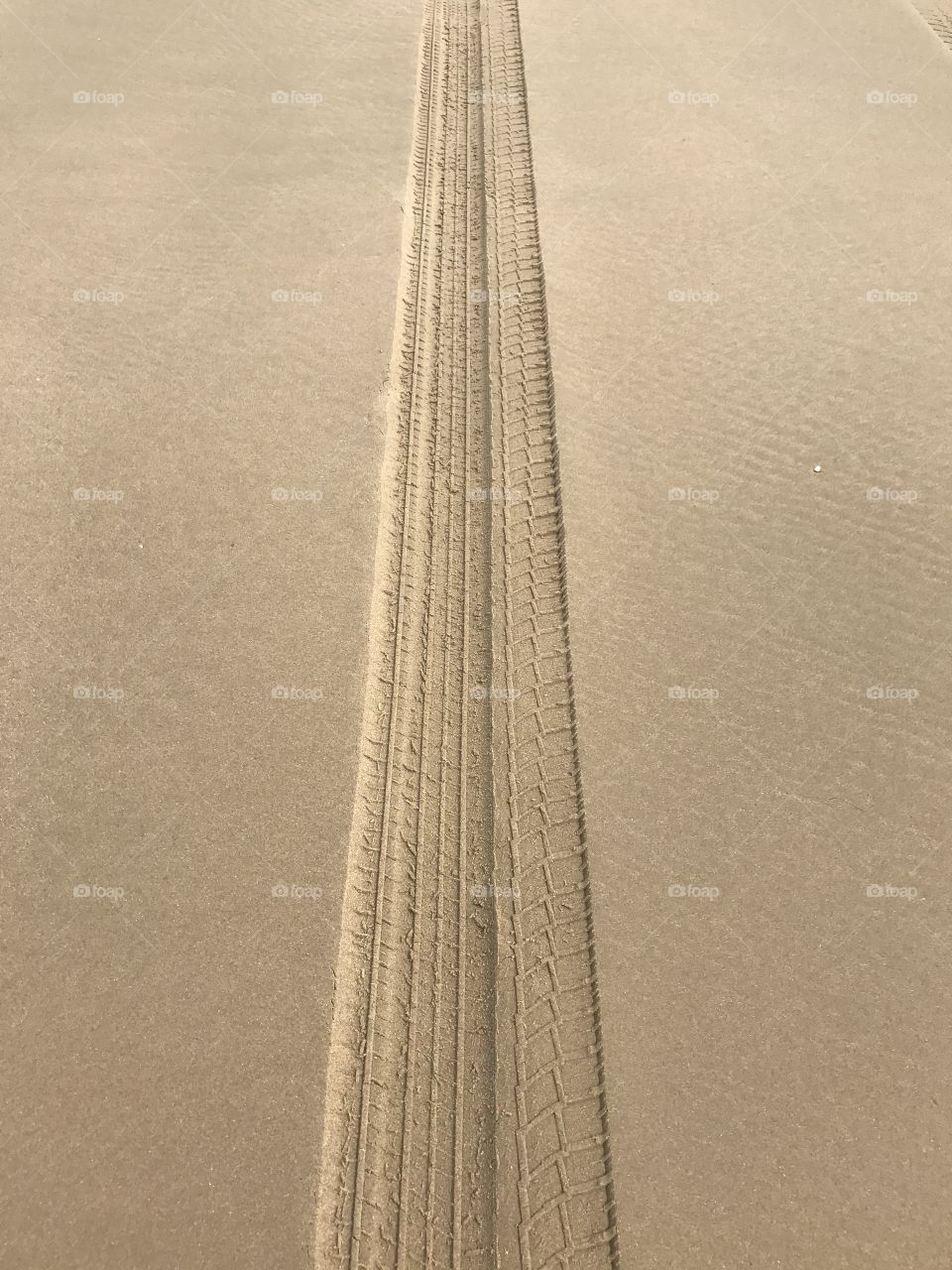 Tyre track on sandy beach