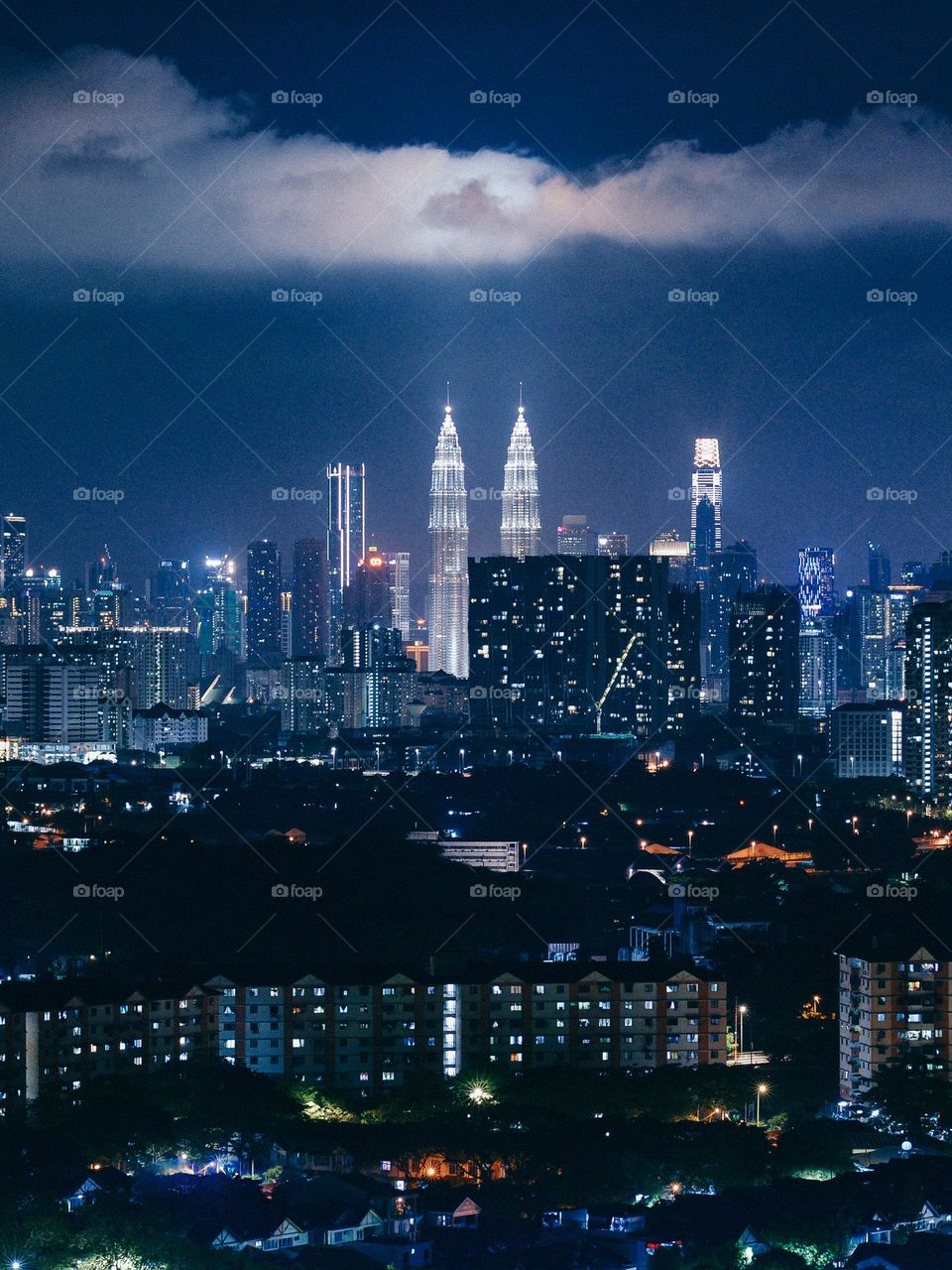 Illuminated clouds above the petronas twin towers in Kuala Lumpur, Malaysia