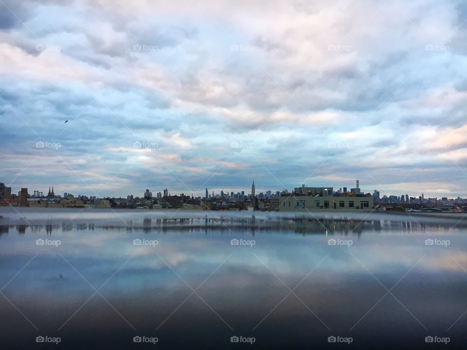 Scenic view of cloud reflecting lake