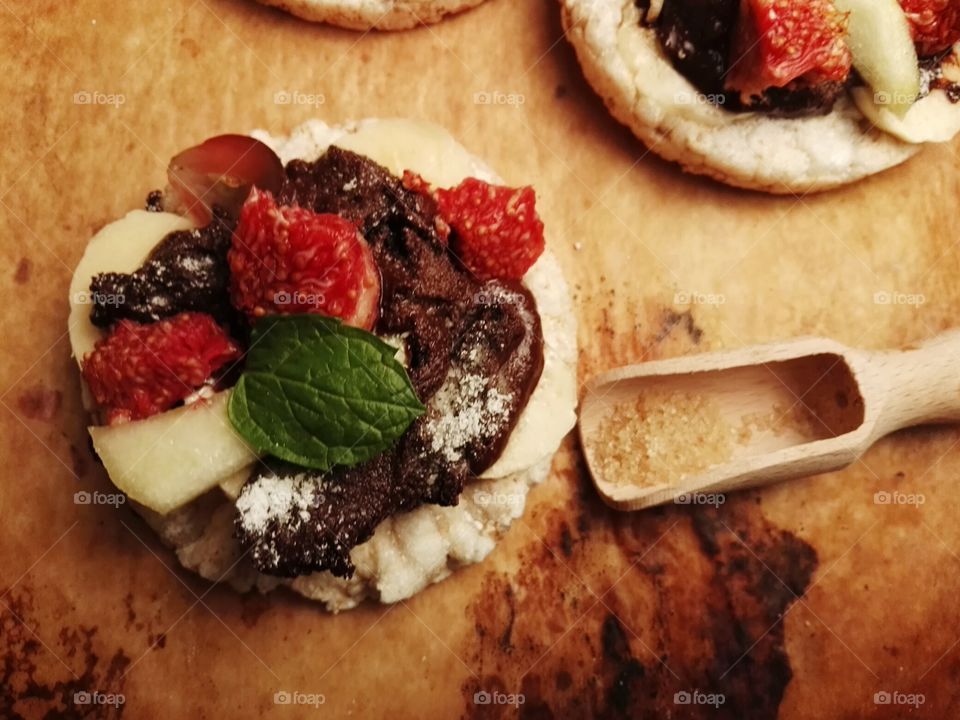 Healthy sweets with fruits and dark chocolate on a rustic background