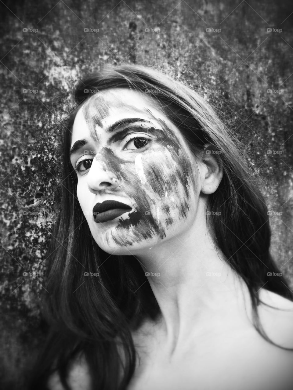 Close-up of a woman with black paint on her face