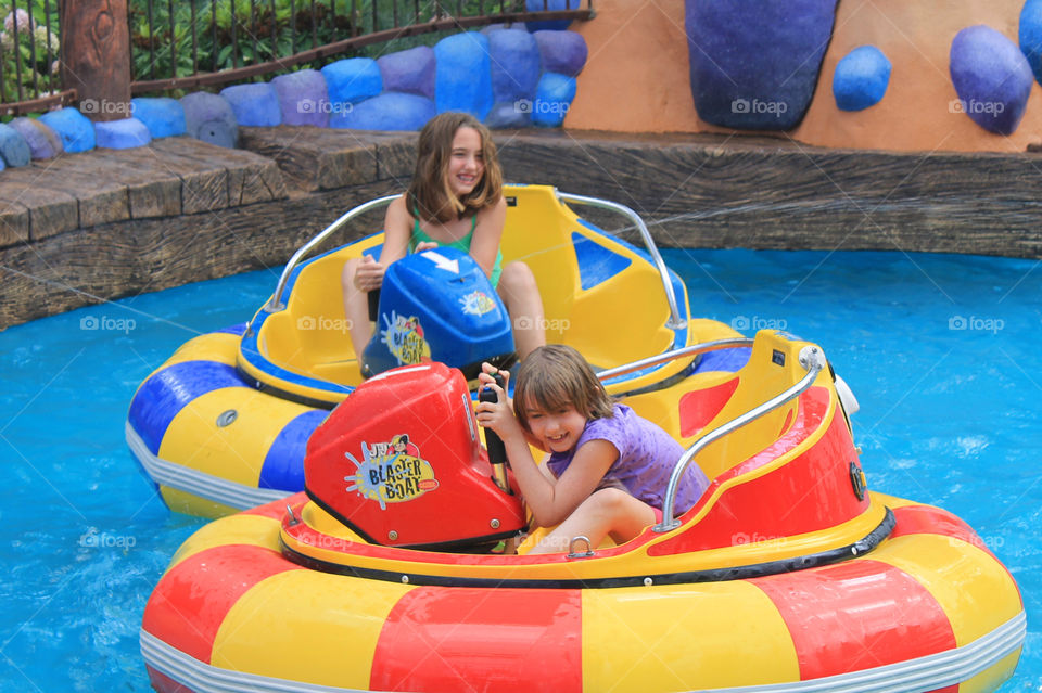 Summertime is for amusement parks! Two of my girls are shown here riding the squirting bumper boats! It was a really hot day so none of us minded getting wet. The water could squirt outside of the pool so even the bystanders, like Mom, got wet! 💦