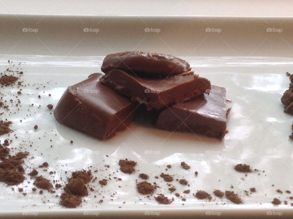 Pieces of fudge with cocoa powder.