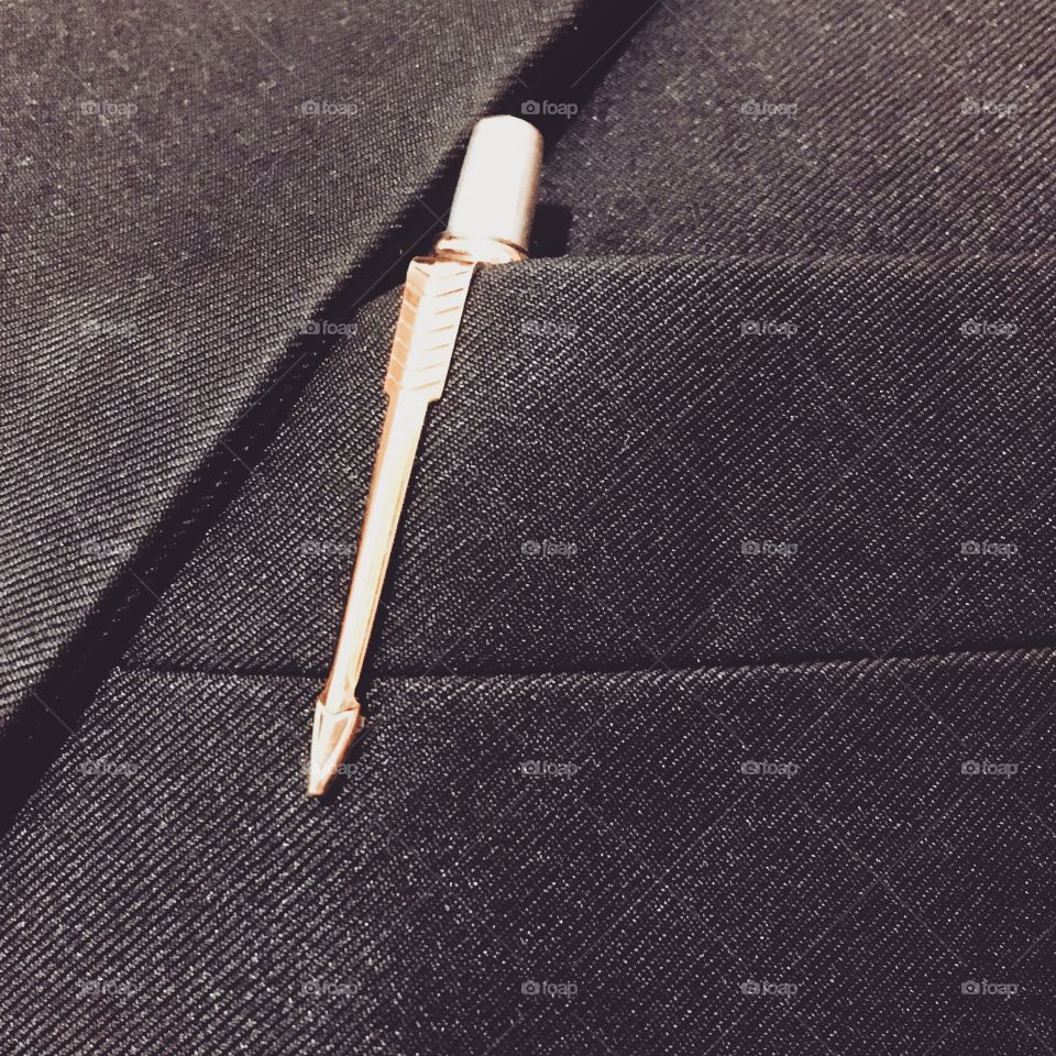 An expensive gold pen clipped on a professional's blazer 