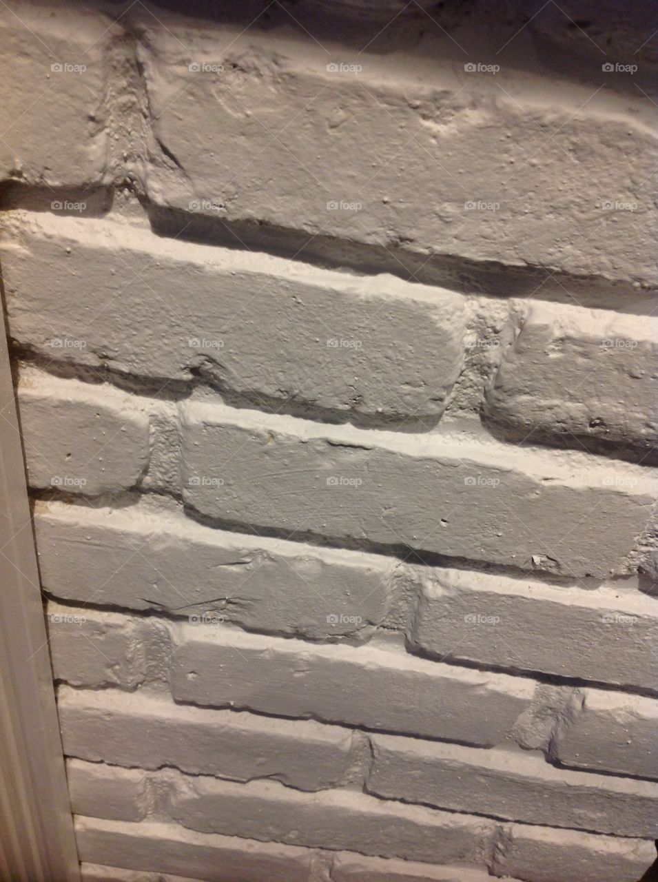 An up close photo of a white brick wall.