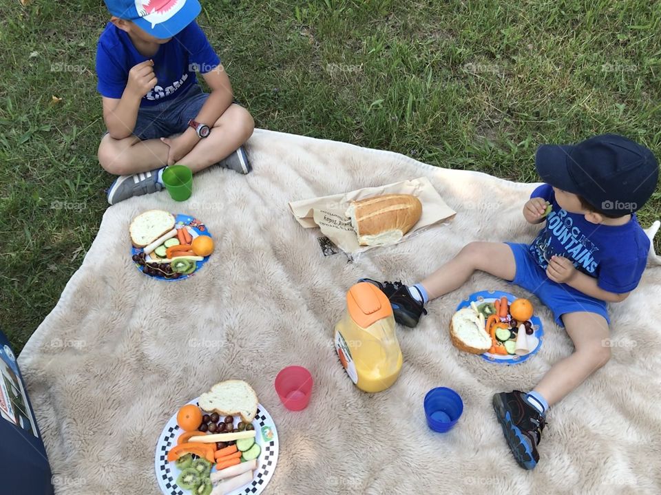 Two young children having a picnic