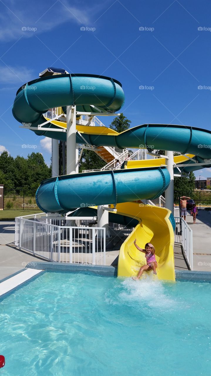 Girl enjoying swirl slide at resort