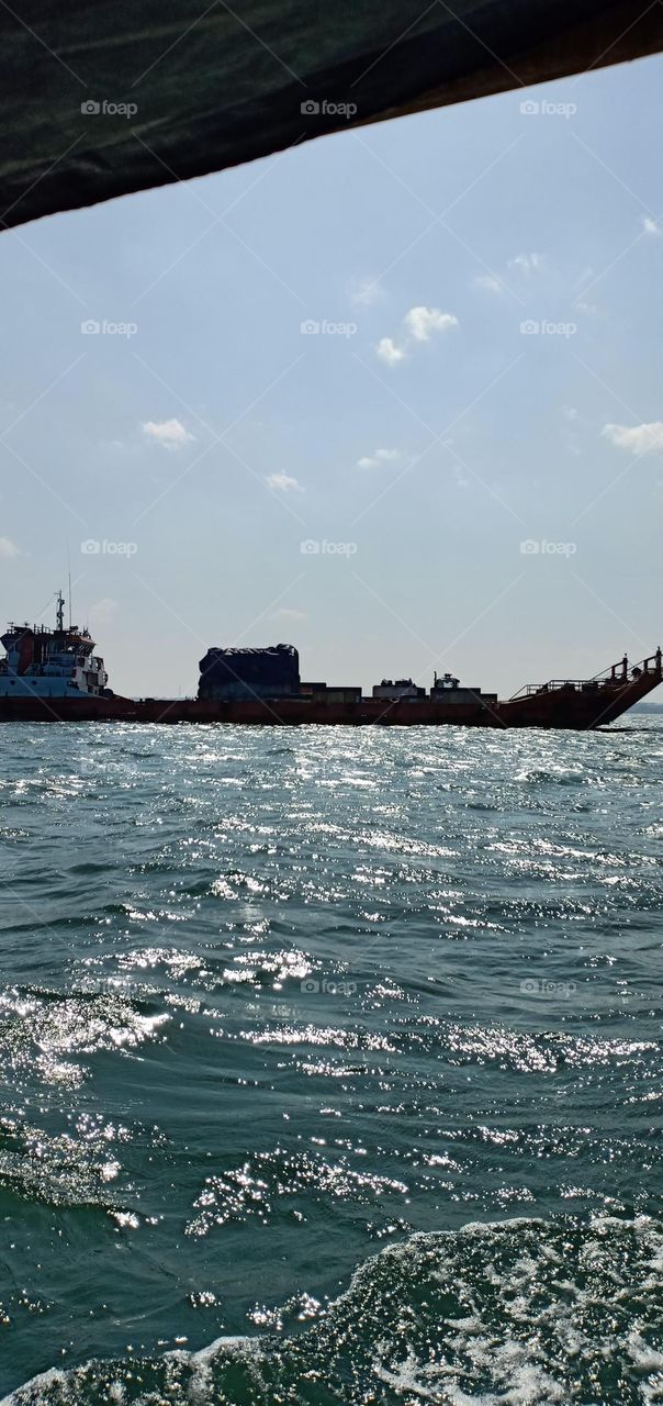 a container ship that is crossing the coast of Jepara, Central Java