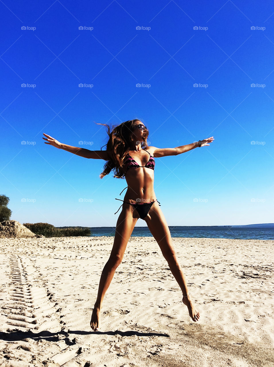 Young fitness woman on the beach 