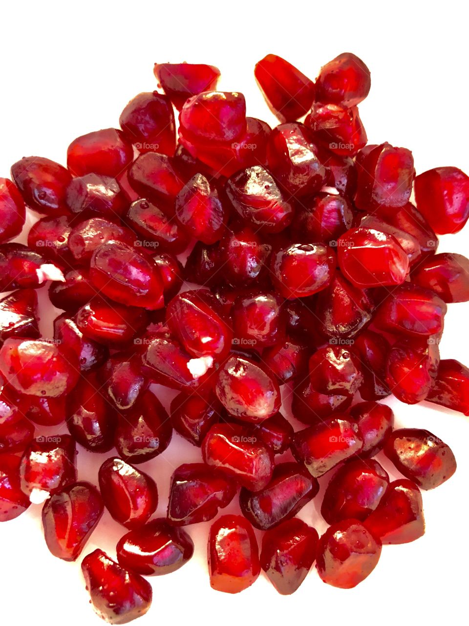 Flatlay of Pomegranate arils on a white surface 