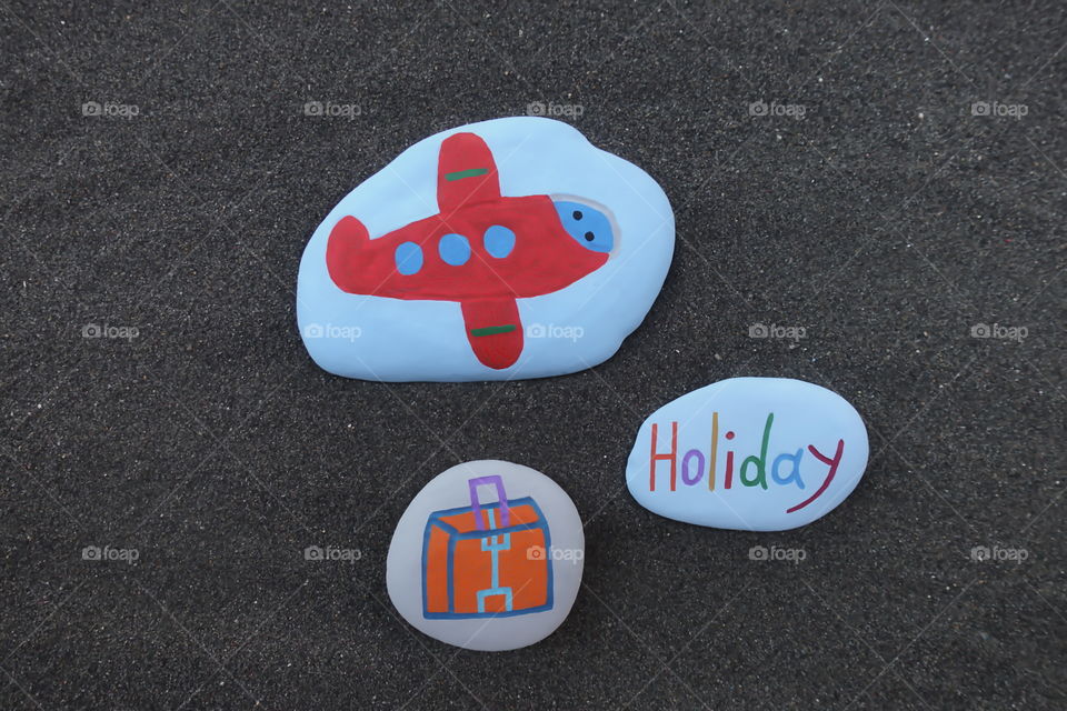 Holiday time with colored stones composition over black volcanic sand