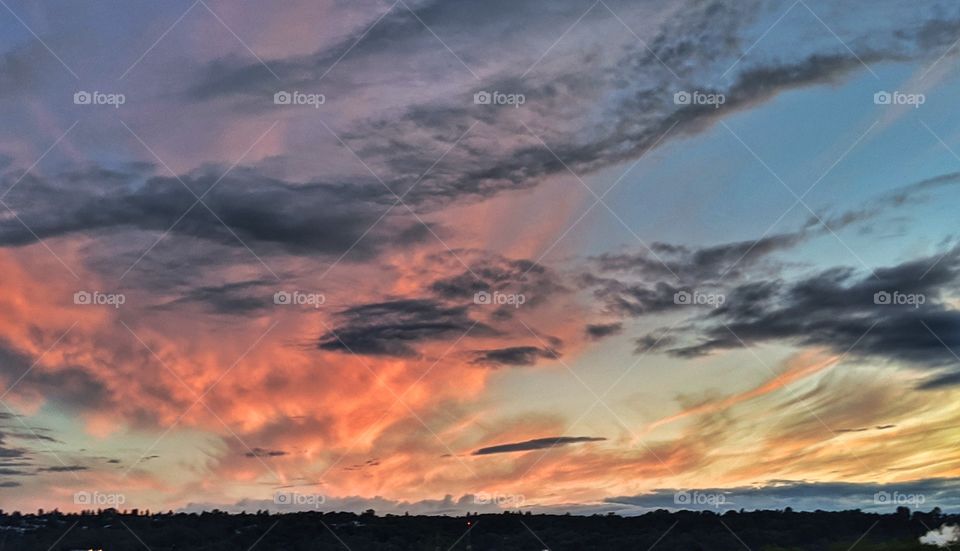 A dramatic, bold and colorful sky during a summer sunset.