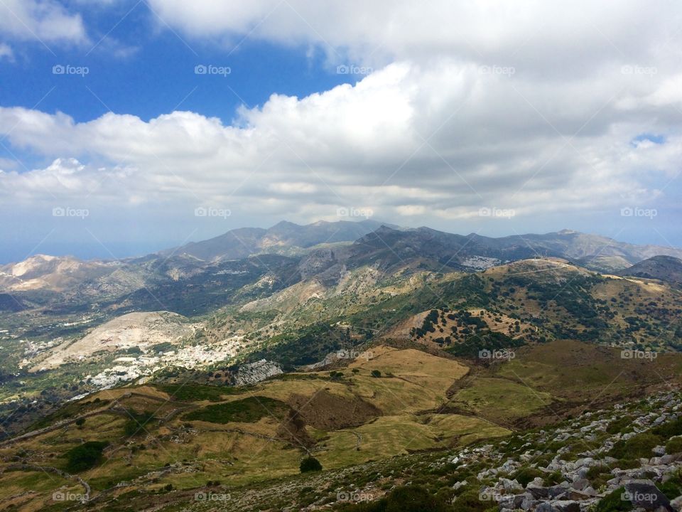 Scenic view of mountains against cloudy sky