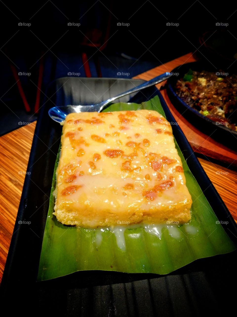 Sweet and delicious cassava cake served in banana leaf.