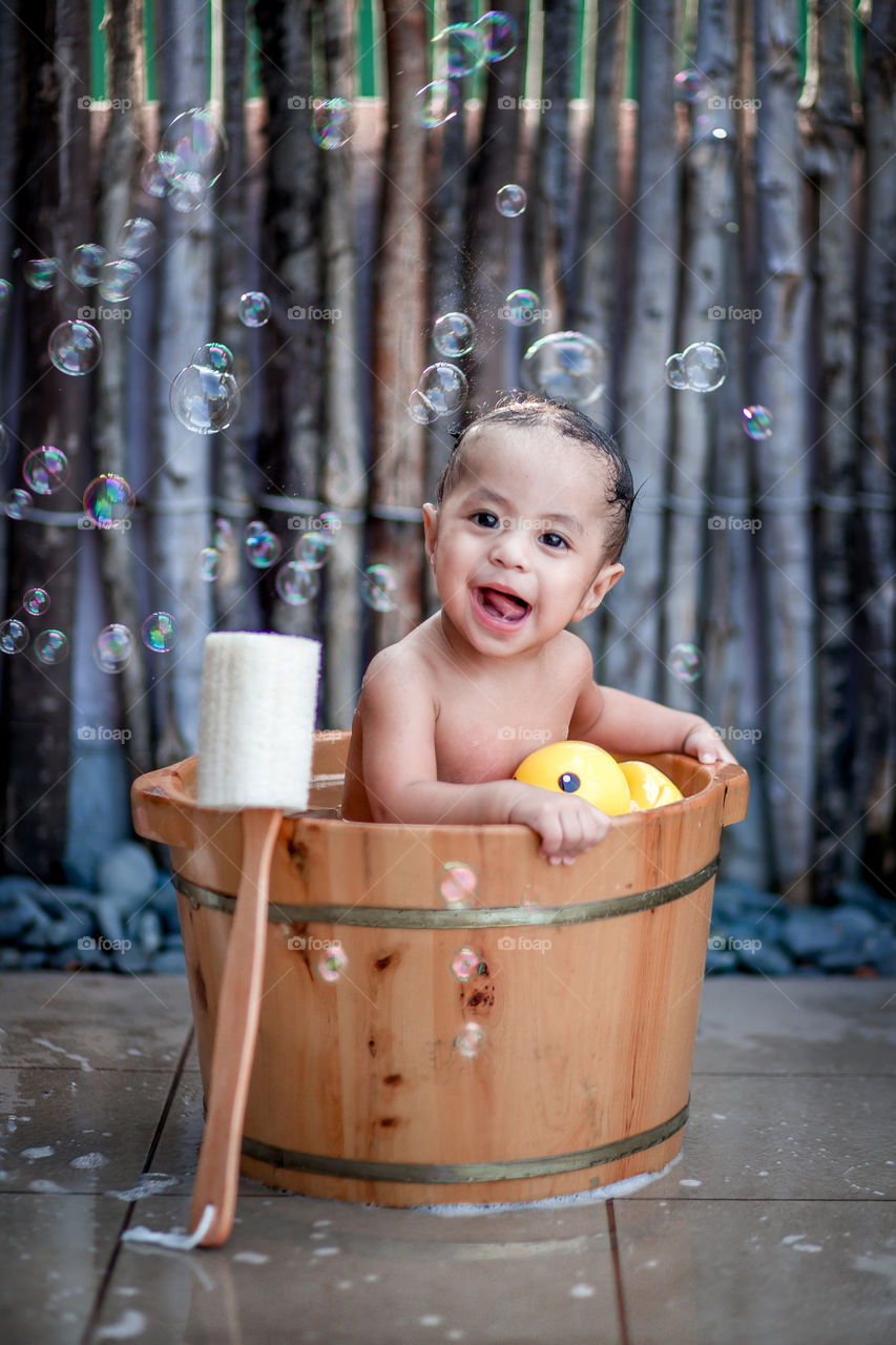 Smiling bathing baby